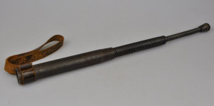 Appraisal: A th century steel spiral rectractable cosh with leather wrist