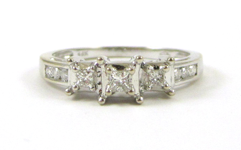 Appraisal: DIAMOND AND FOURTEEN KARAT WHITE GOLD RING with three princess-cut