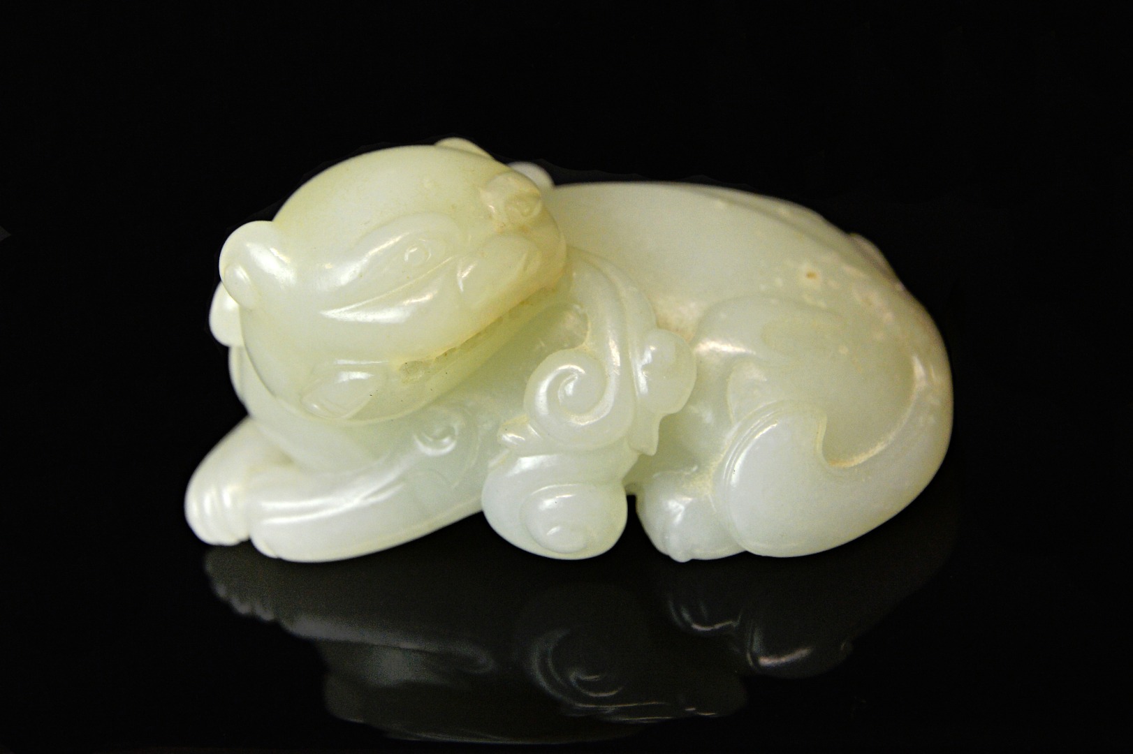 Appraisal: A Chinese pale celadon jade Buddhist lion th th century