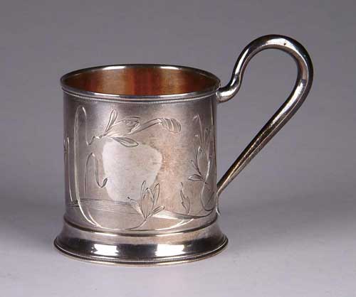 Appraisal: RUSSIAN SILVER HANDLED CUP The high loop handle attached to