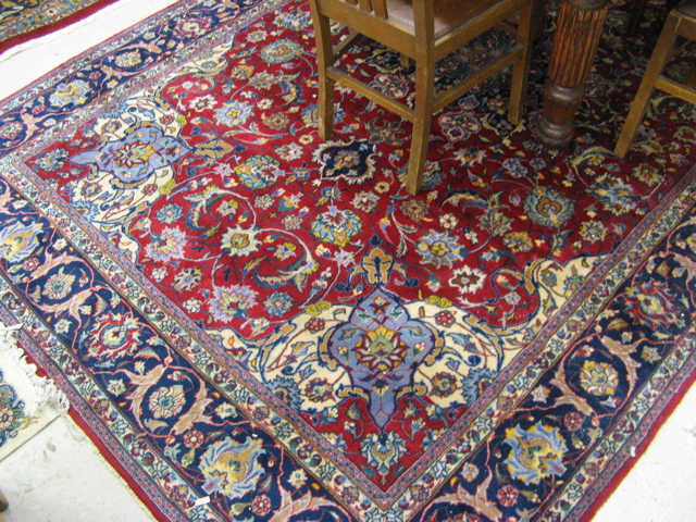 Appraisal: PERSIAN CARPET floral and central floral medallion design on crimson