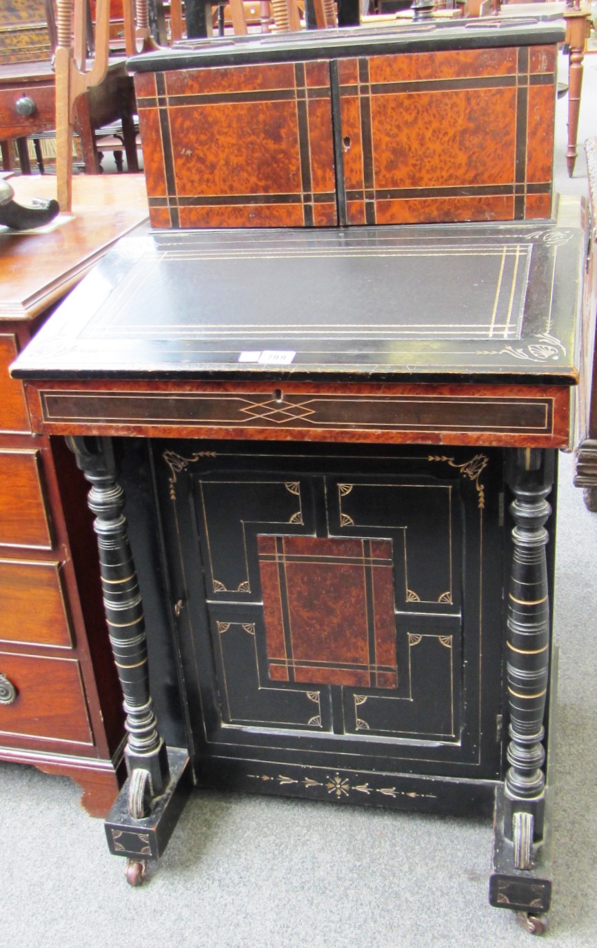 Appraisal: A Victorian ebonised parcel gilt Aesthetic Movement Davenport with fitted