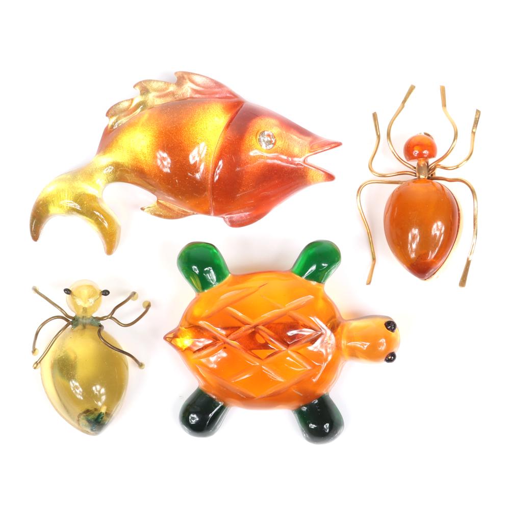 Appraisal: FOUR LUCITE ANIMAL PINS TWO YELLOW AND AMBER JELLY BELLY