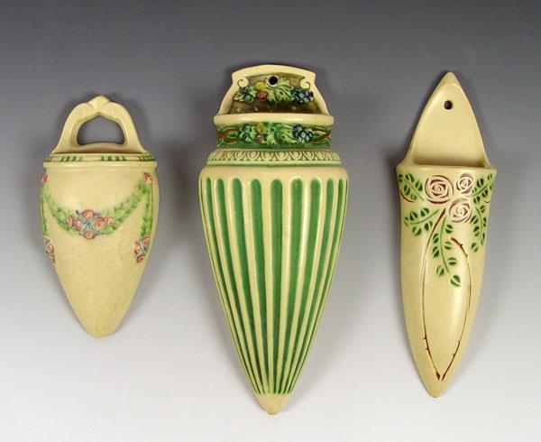 Appraisal: THREE ROSEVILLE POTTERY WALL POCKETS LaRose Corinthian and Velmoss Scroll