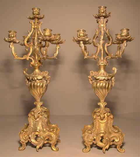 Appraisal: PAIR OF CONTINENTAL GILT-METAL CANDELABRA cast with four scrolling feet