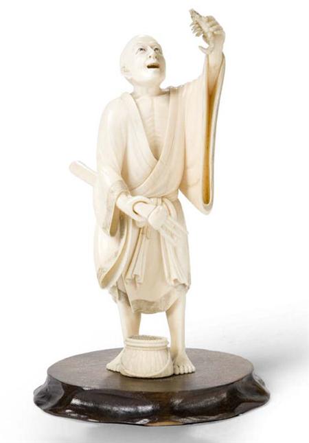 Appraisal: A Japanese ivory okimono Meiji period carved as a fisherman