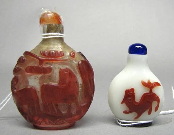 Appraisal: Two red-overlay decorated Peking glass snuff bottles The larger with