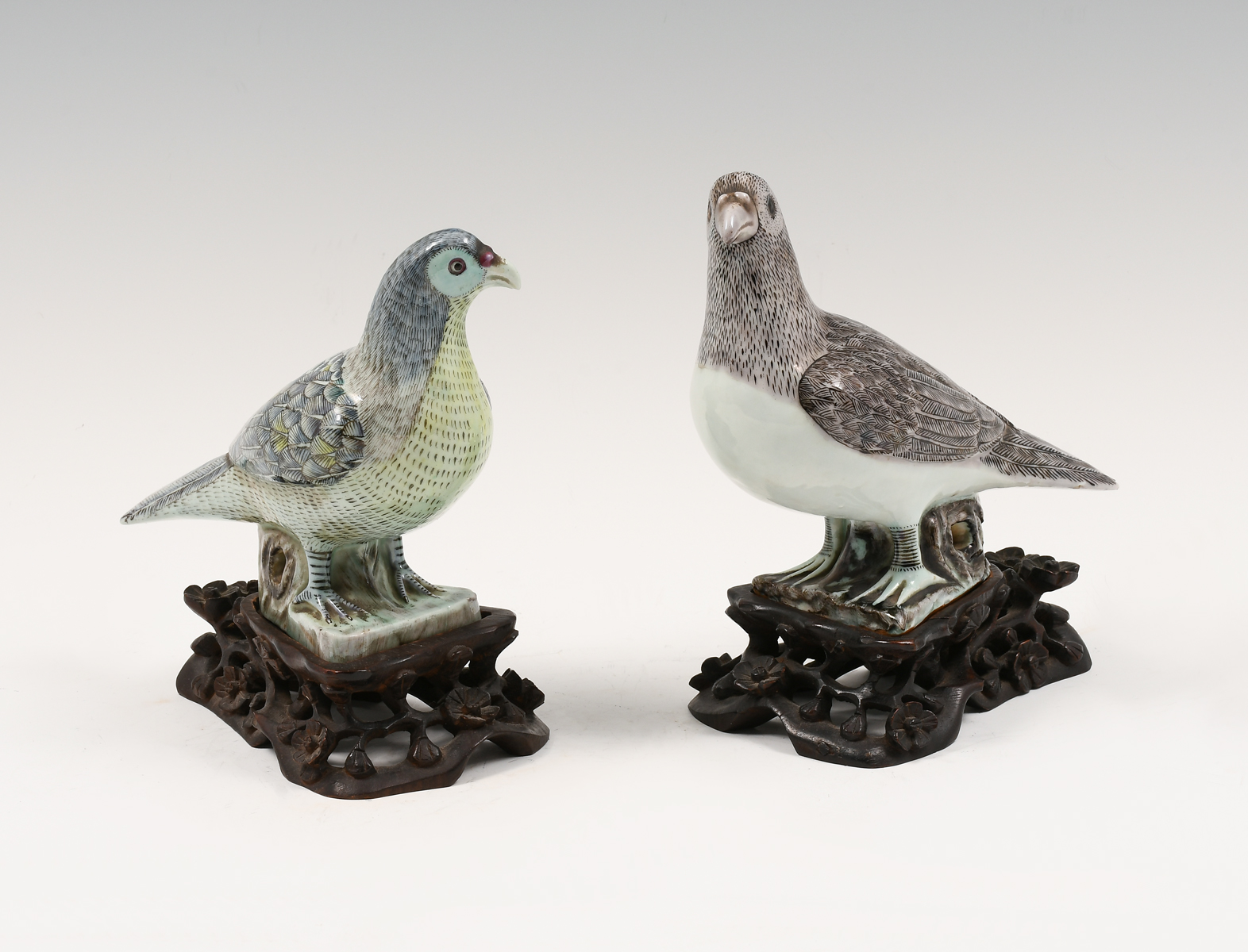 Appraisal: SET OF CHINESE PORCELAIN BIRDS ON CARVED STANDS Two-piece Male