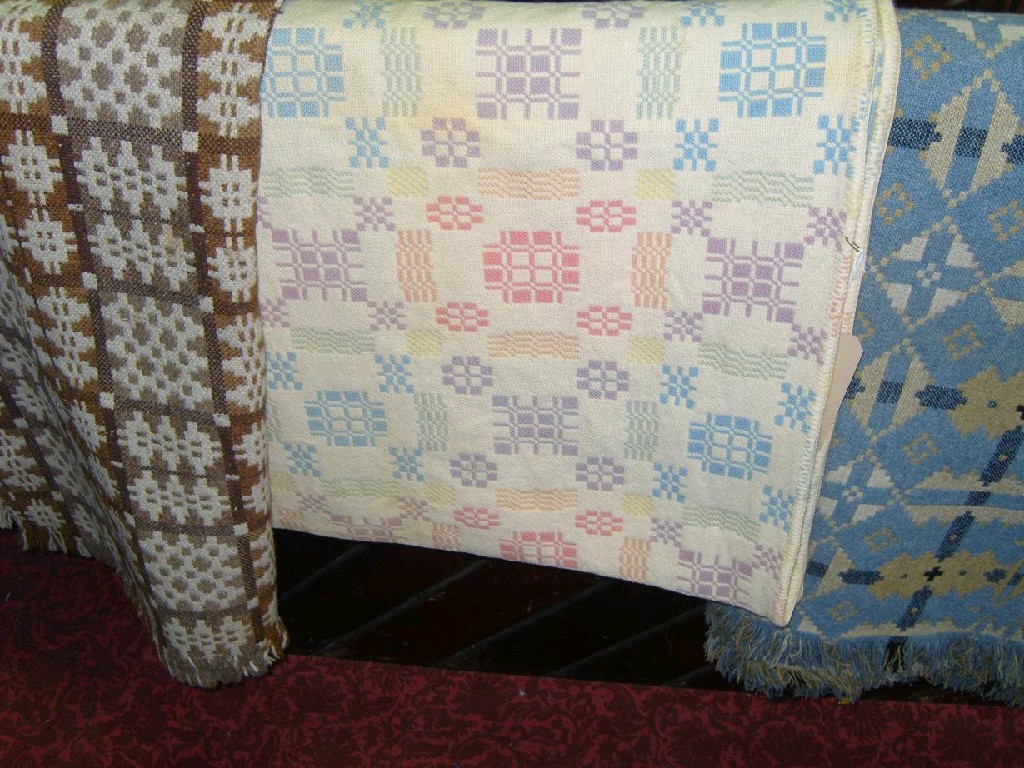 Appraisal: A Welsh wool blanket with pastel geometric decoration on a