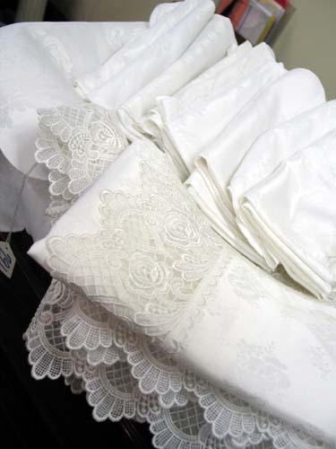 Appraisal: TWO WHITE FORMAL TABLECLOTHS AND NAPKINS One of the tablecloths