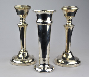 Appraisal: A pair of loaded silver candlesticks Birmingham cm to w