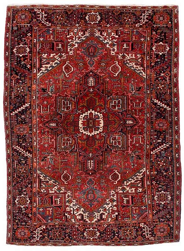 Appraisal: Heriz Carpet red field with geometric design in blues pinks