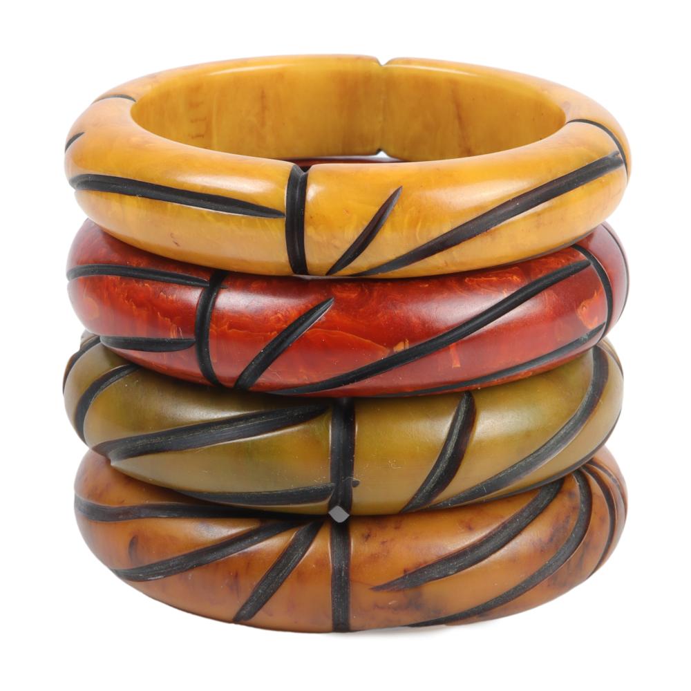 Appraisal: FOUR BAKELITE GEOMETRIC DEEPLY CARVED AND OVER DYED RESIN WASHED