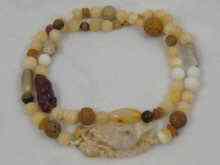 Appraisal: A Chinese necklace with carved jade agate and amber approx