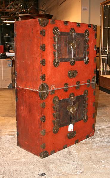 Appraisal: A red lacquered wood two-part cabinet yi chong nong With