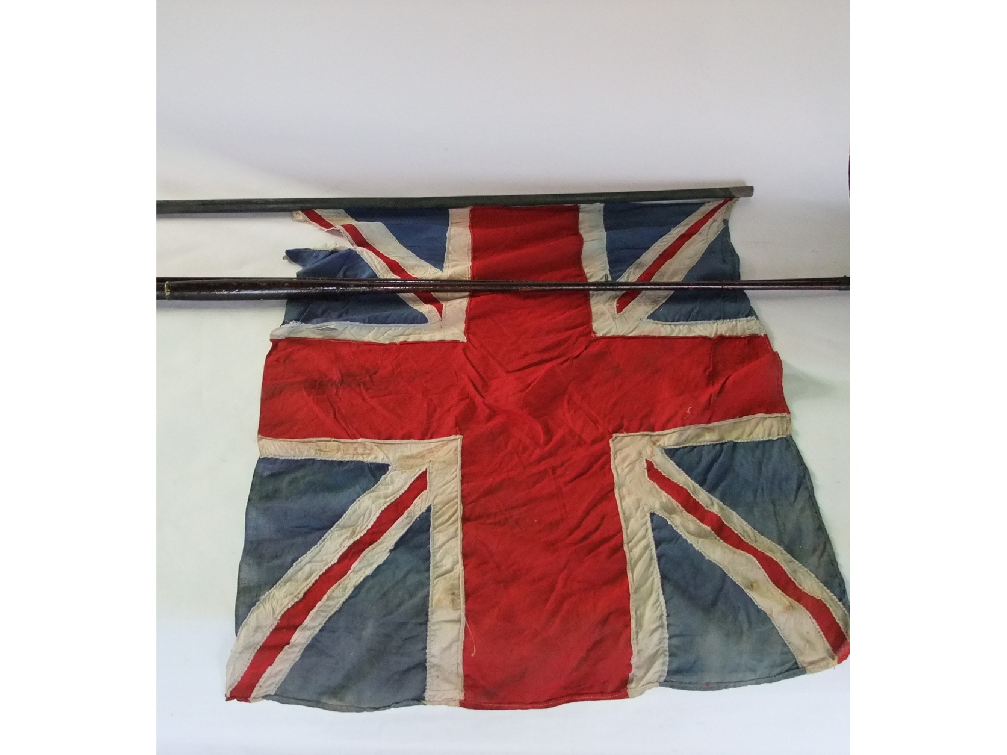 Appraisal: A vintage Union Jack flag suspended on a rustic stained