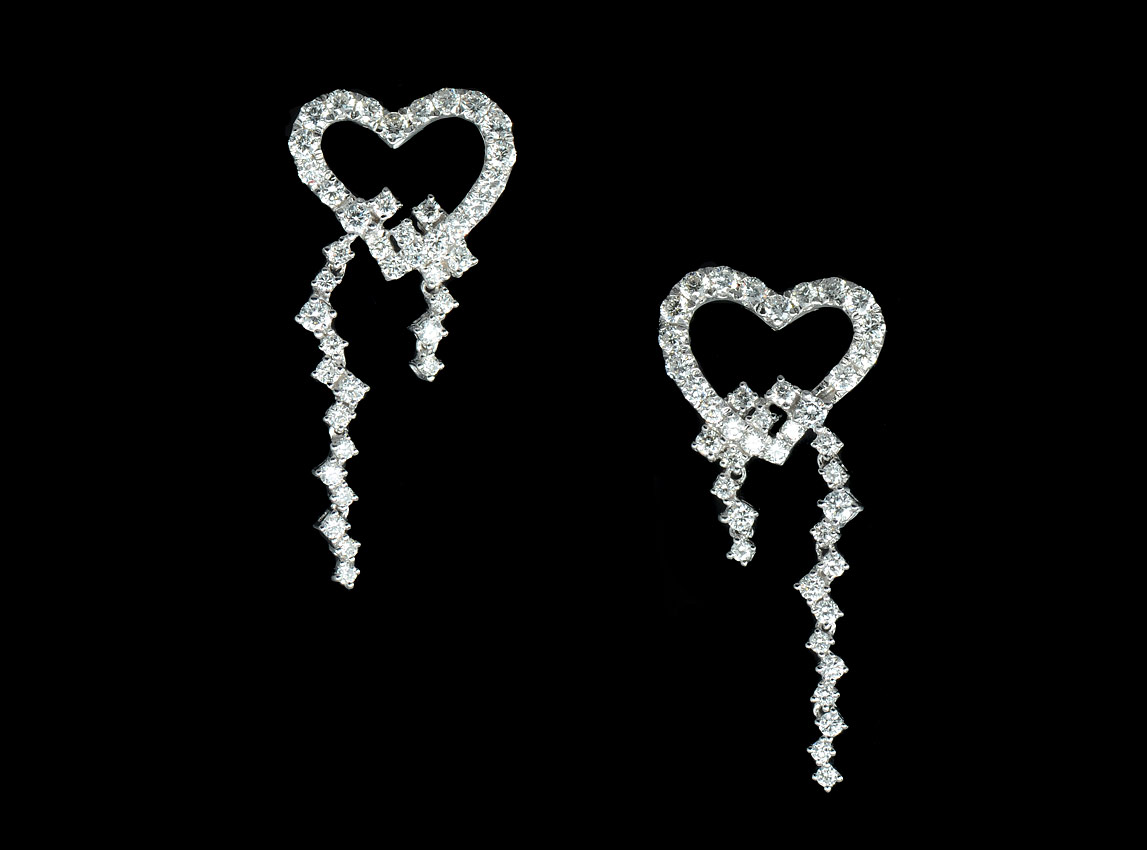 Appraisal: K WHITE GOLD DIAMOND EARRINGS Stylized hearts of round brilliant