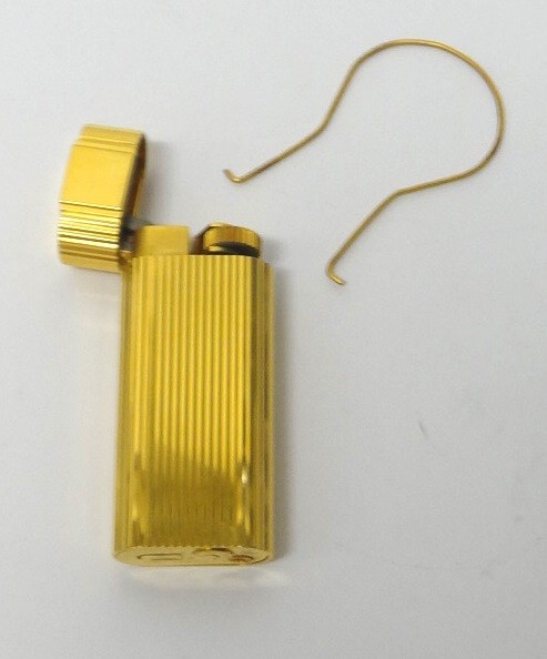 Appraisal: A Cartier gilt metal curved rectangular cased gas lighter with