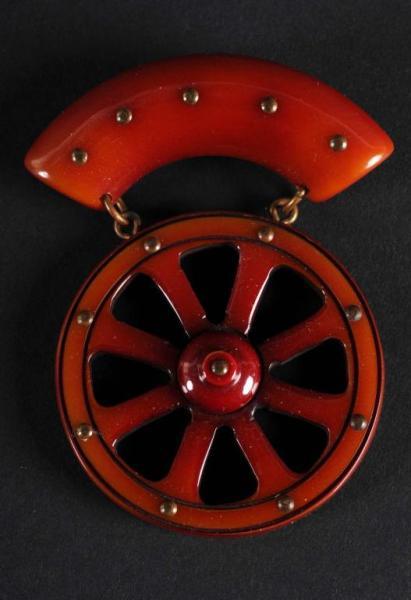 Appraisal: Bakelite Dark Red Wagon Wheel Pin Condition Excellent Size -