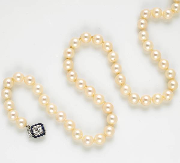 Appraisal: A cultured pearl diamond sapphire and platinum necklace pearls measuring