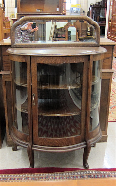 Appraisal: AN OAK AND CURVED GLASS HALF-SIZE CHINA CABINET American c