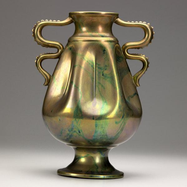 Appraisal: ZSOLNAY Footed and dimpled urn with serpent handles covered in