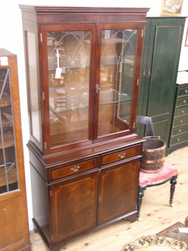 Appraisal: A reproduction mahogany bookcase upper stage with a pair of