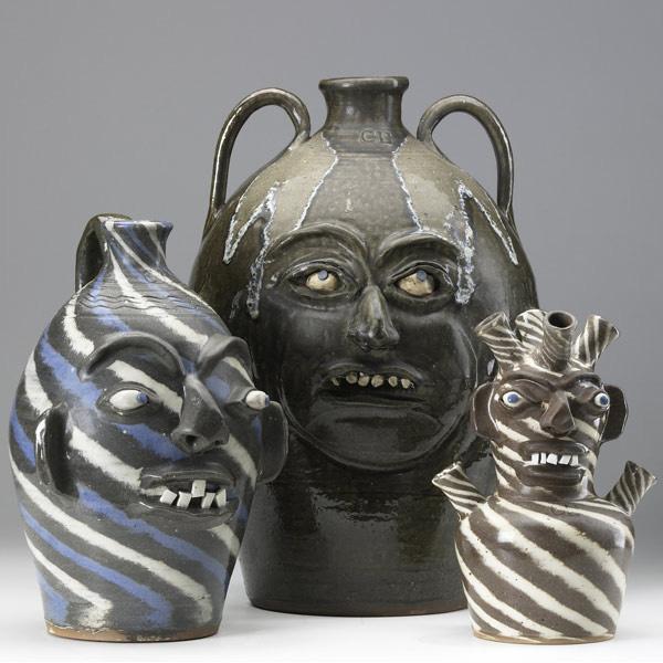 Appraisal: CHARLES LISK Three Folk Art face jugs one of marbleized