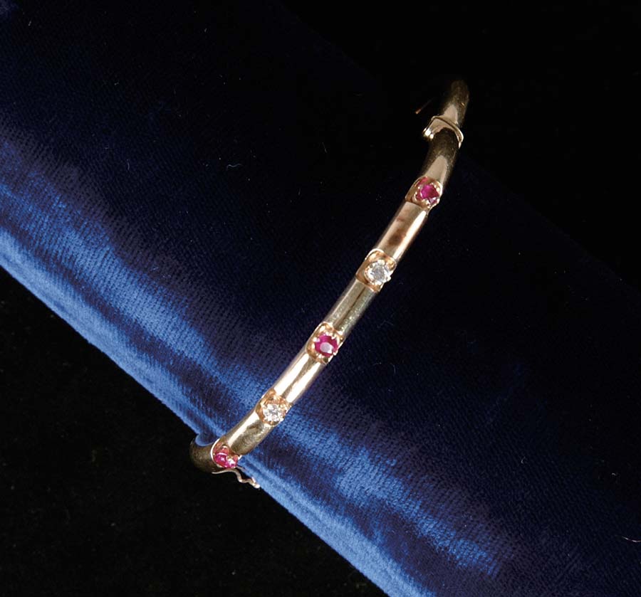 Appraisal: RUBY DIAMOND BANGLE BRACELET k yellow gold bangle is set