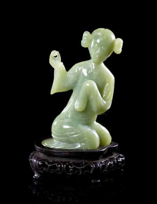 Appraisal: A Jadeite Carving of a Kneeeling Figure depicting a girl