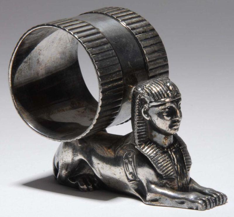 Appraisal: Egyptian Sphinx Figural Napkin Ring Description Napkin holder rests on