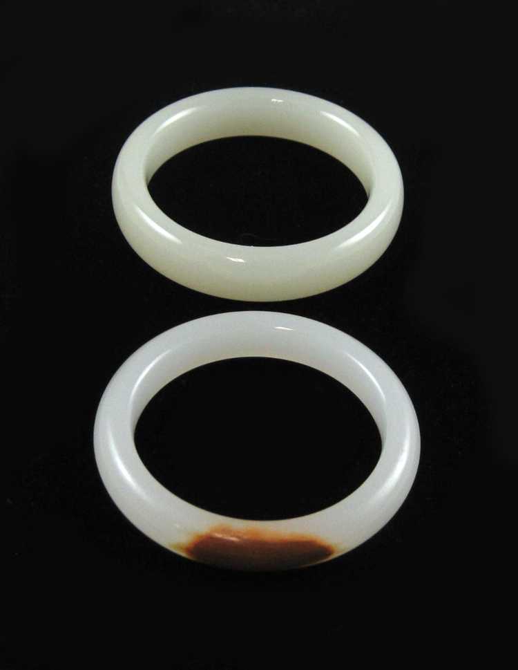 Appraisal: TWO ROUND TRANSLUCENT JADE BANGLES including a light green jade