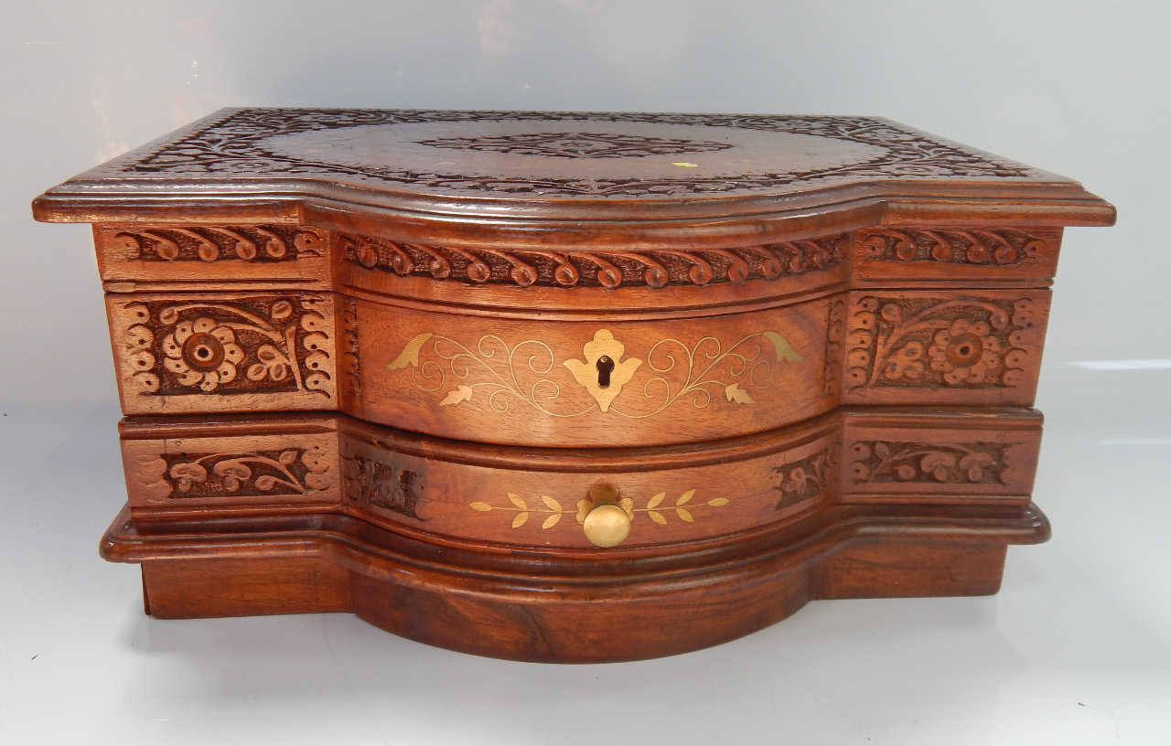 Appraisal: An inlaid and relief carved mahogany jewellery box cm wide