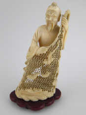 Appraisal: A Japanese ivory figure of a fisherman displaying his net