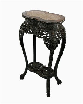 Appraisal: A Chinese hardwood stand deeply carved with prunus and foliage