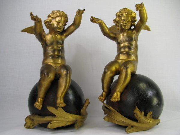 Appraisal: A pair of dore bronze and ebonized garnitures of cherubs