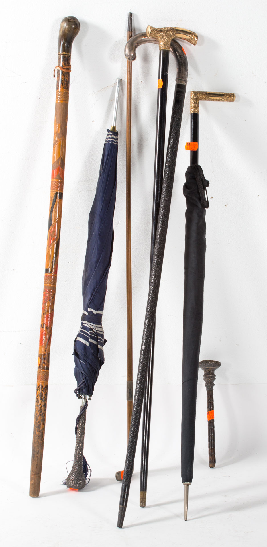 Appraisal: Assortment of canes and umbrellas including several with gold and