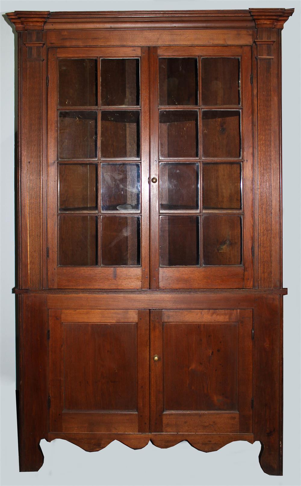 Appraisal: AMERICAN WALNUT CORNER CUPBOARD the corner cupboard in one piece