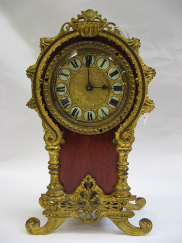 Appraisal: MAHOGANY CASED MANTLE CLOCK spring wound ornately accented with gilt