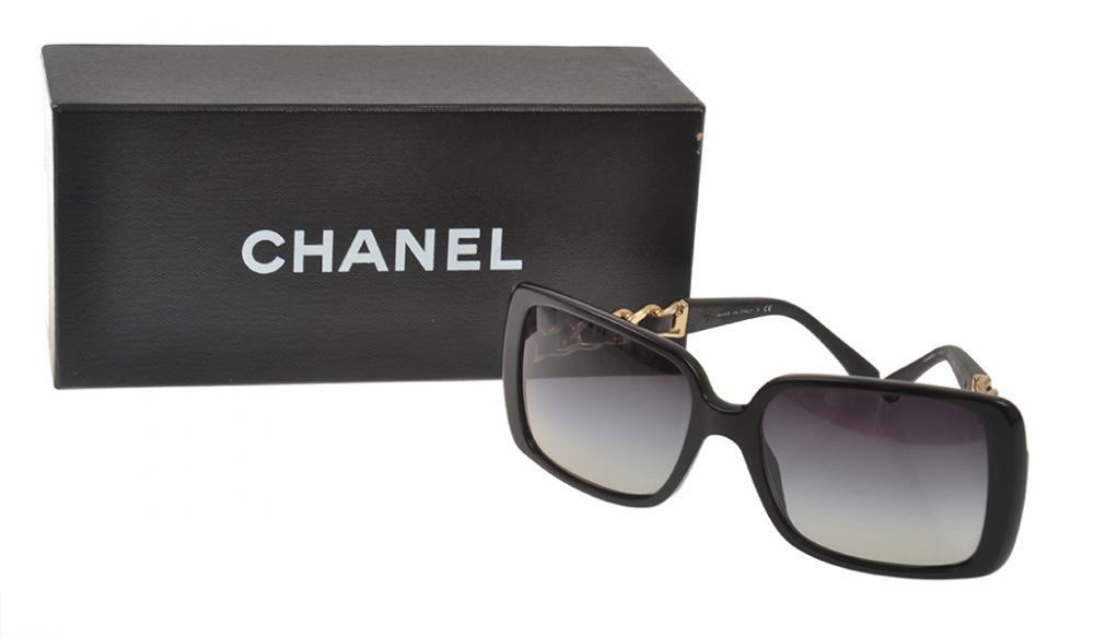 Appraisal: A PAIR OF SUNGLASSES BY CHANEL Styled in black composite