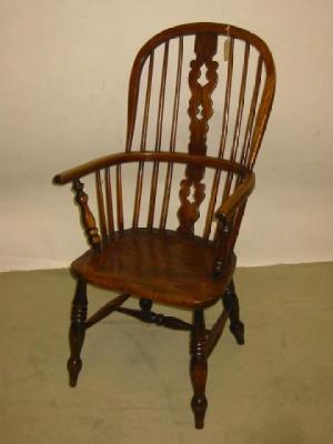 Appraisal: AN ASH AND ELM WINDSOR ARMCHAIR of high hoop back