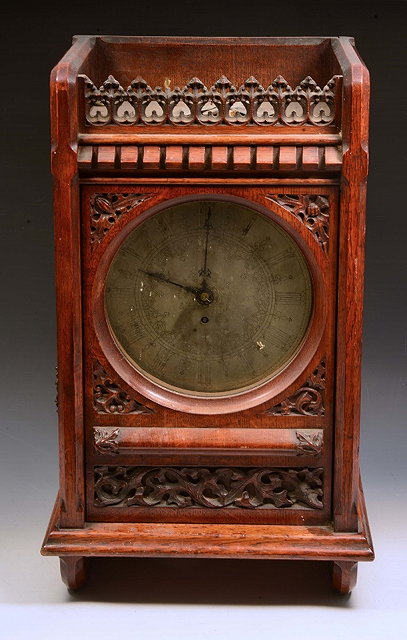 Appraisal: A VICTORIAN OAK CASED LIBRARY CLOCK with circular engraved steel