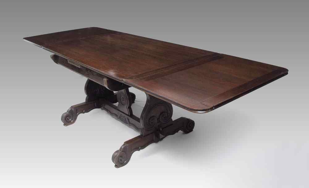 Appraisal: COUNTRY FRENCH OAK DRAW LEAF TRESTLE TABLE Carved lyre supports