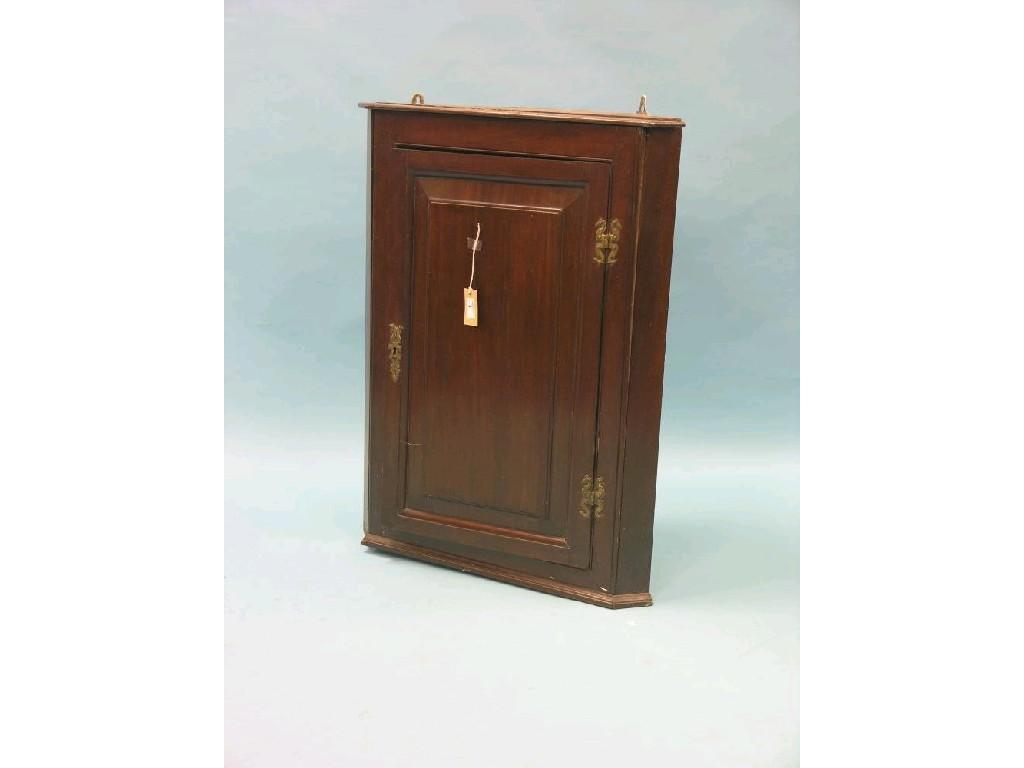 Appraisal: A George III red walnut corner cupboard two shaped shelves