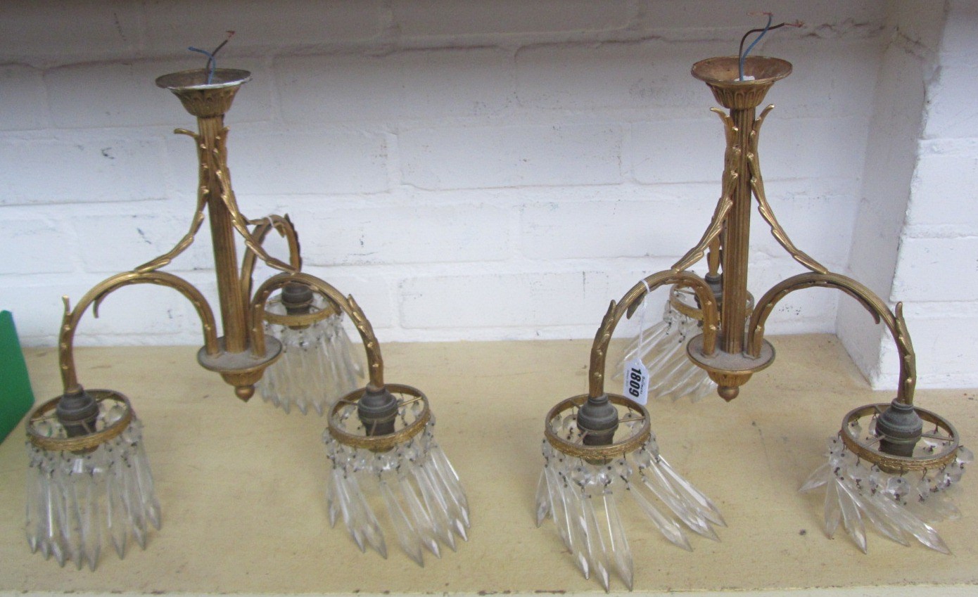 Appraisal: A pair of brass three light ceiling lights of Regency