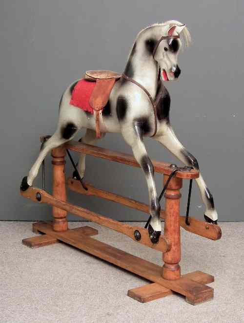 Appraisal: A modern painted wood dapple grey rocking horse on stained