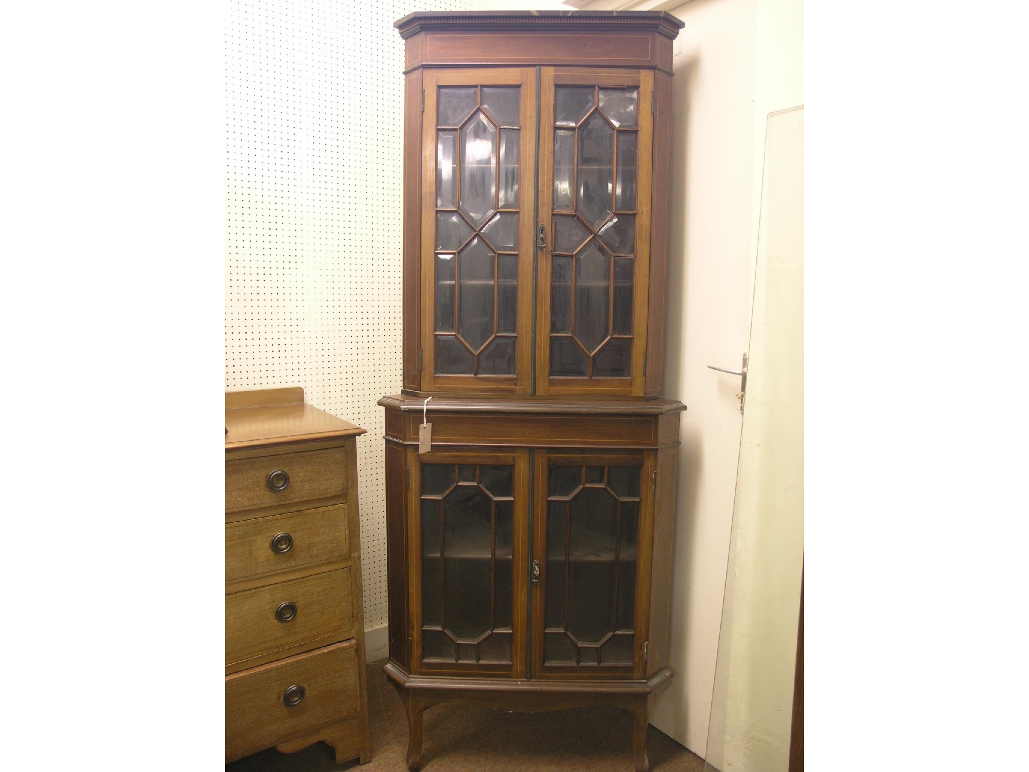 Appraisal: An Edwardian inlaid mahogany corner cabinet floor-standing enclosed by two