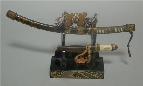 Appraisal: MINIATURE LACQUER SWORD STAND AND SWORDS The set contained in