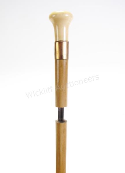 Appraisal: Sword Cane With Gold Collar solid wood shaft separates to