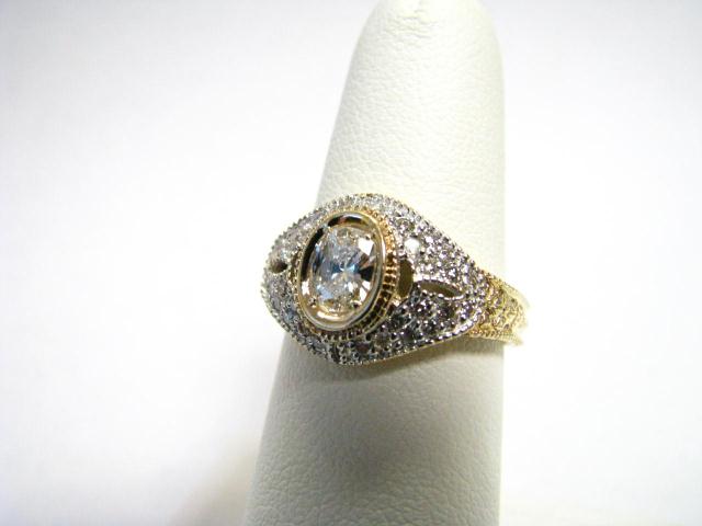 Appraisal: Lady's K yellow gold ring with center diamond and accent